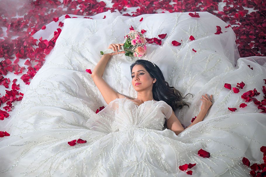 Woman Lycing on a Bed of Roses in a Wedding Dress | Nikon Cameras, Lenses & Accessories